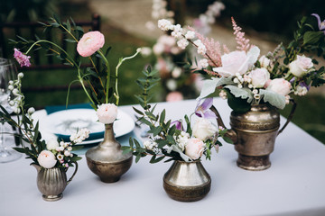Wedding table decoration in rustic style. Wedding flowers.