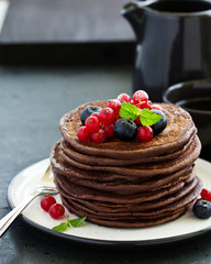 Chocolate pancakes with berries.