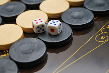 Obraz na płótnie Canvas Backgammon Table Game Board. Color detail of a Backgammon game with two dice. Board game backgammon. Selective focus