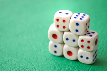 White dices on green background. Selective focus