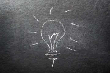 Light bulb - painting with chalk on blackboard, can be used as idea, brainstorming or ecology concept