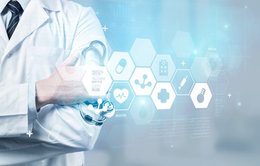 Male doctor with stethoscope on blurred hospital background