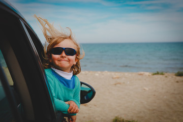 cute happy little girl enjoy travel by car at sea