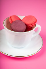 Berry macaroons in a white cup