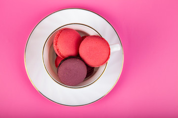 Berry macaroons in a white cup