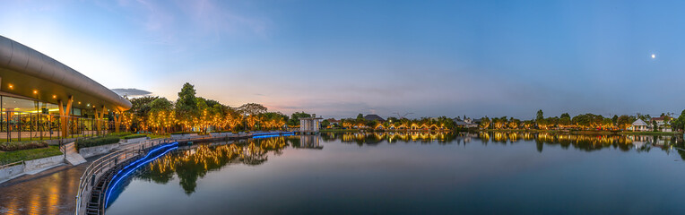 Obraz premium Bangkok, Thailand. Lighting for new year 2019 decorated around village lake at sunset. Light reflection around lagoon.