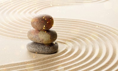 Fototapeta na wymiar Zen stones in the sand. Beige background