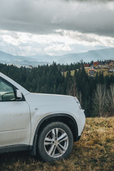 Fototapeta premium white suv car car travel concept mountains on background