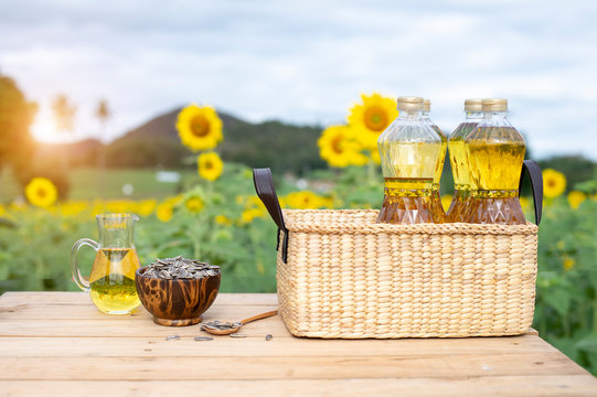 Wicker basket with sunflower, sun flower seed and  bottles of oil on the background of the farm