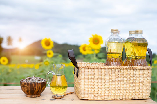 Wicker basket with sunflower, sun flower seed and  bottles of oil on the background of the farm