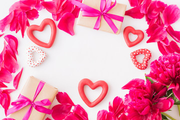 Valentines day composition with red peonies and gift box on a light background
