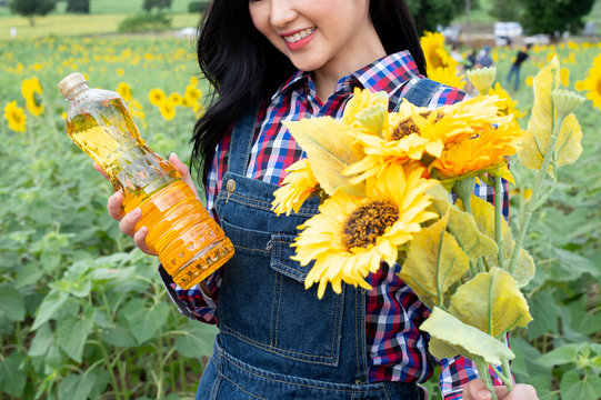 Asian girl with sunflower seeds is sunflower oil.