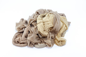 Group of used women nylon tights pantyhose beige colour on isolated white background.