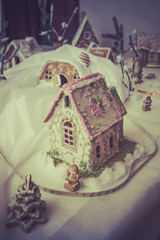 gingerbread houses on a backlit table