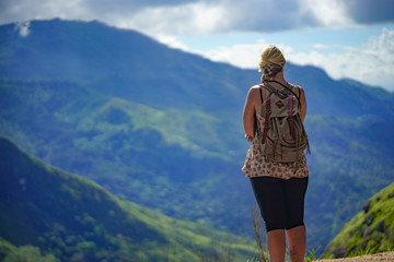 Naklejka premium young woman on the top of mountain