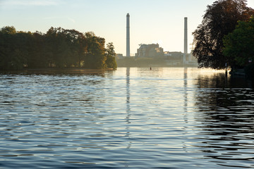 factory at calm river in early morning light