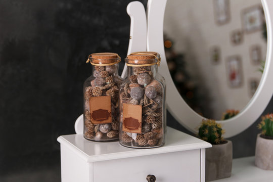 Decorative jars with dry nuts decorate a room interior