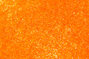 Flame-orange glass beads background - closeup beads texture