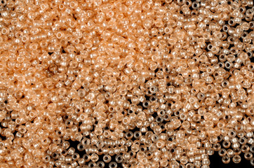 Flame-orange glass beads background - closeup beads texture