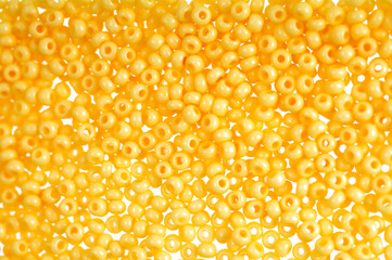 Flame-orange glass beads background - closeup beads texture