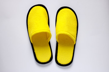 Bright soft yellow homemade slippers on a white background