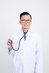 Doctor holding stethoscope on white background