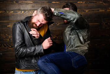 Men brutal hooligans wear leather jackets fighting. Physical attack. Men bearded hipster fighting....