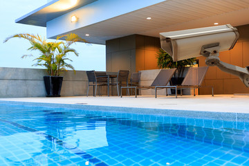 CCTV security camera secure to protect at outdoor swimming pool and terrace upper deck. Copy space.