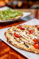 Tomato and Balsamic Vinaigrette Flatbread with mozzarella, goat cheese and parmesan