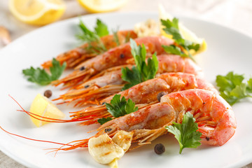 Grilled shrimps with spice, lemon and greenery. Grilled seafood.