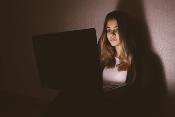 Teenager girl suffering internet cyber bullying scared and depressed cyberbullying. Image of...
