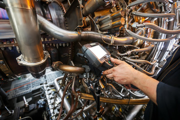 Inspection of a gas turbine engine using a Video Endoscope. Search for defects inside the turbine and shooting on video, photos using a measuring instrument. © Alexander