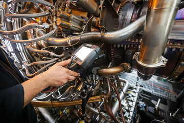Inspection of a gas turbine engine using a Video Endoscope. Search for defects inside the turbine and shooting on video, photos using a measuring instrument.