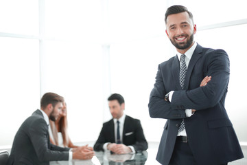 successful business man standing in a bright office