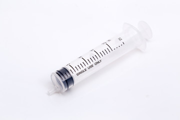 Closed up syringe on isolated background.