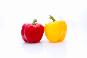 Couple of red and yellow bell pepper on isolate white background with copy space.