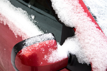 Fluffy snow covered red car