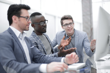 employees using a computer to analyze data