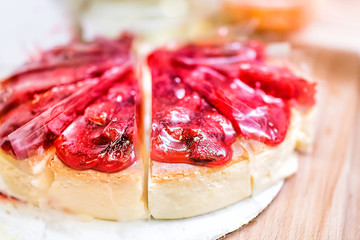 Closeup of strawberry baked cheesecake cake slices with syrup showing detail, texture of red berries marmalade whole