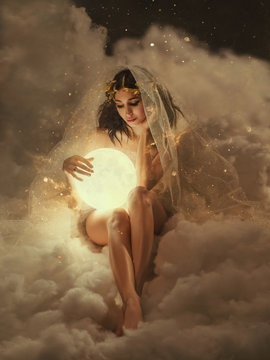 gorgeous slender sexy lady sits in the clouds and holds the moon in her hands. daughter of the sun and sky, keeper of dreams, ready to do good and a fairy tale under the cover of night and the stars