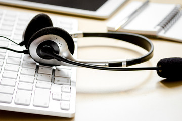 headset and keyboard on workdesk for call center concept