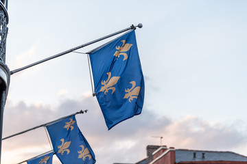 New Orleans old town street in Louisiana famous town, city, fleur-de-lis blue flags hanging off...