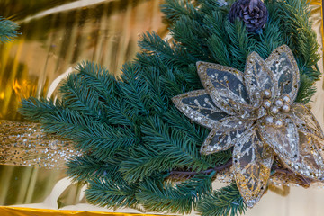 Christmas gold box with gifts. Golden balls and illuminated garland with flashlights.