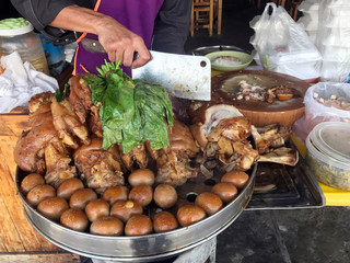 Stewed pork leg at rice shop, Egg and Pork in Sweet Brown Sauce, Cooked Stewed pork leg warmed, Egg and Pork in Sweet Brown Sauce, Boiled eggs in sweet gravy with herb, Popular street foods Thailand