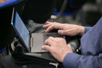 Closeup of human hand writing at a conference.