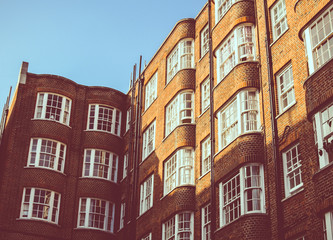 Fototapeta na wymiar Vista di un palazzo Londinese con finestre bianche e mattoni marroni