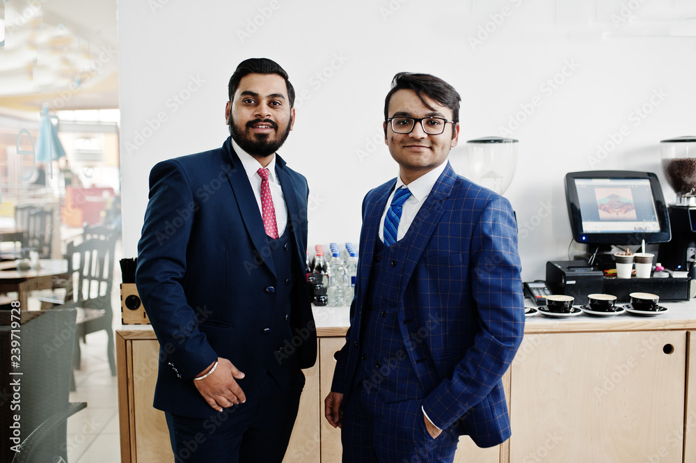 Wall mural two indian businessman in suits standing on cafe.