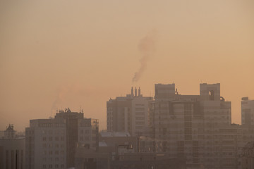 city in smog and fog, buildings silhouettes
