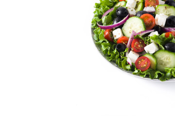 Fresh Greek salad in Plate with black olive,tomato,feta cheese, cucumber isolated on white background. Copyspace