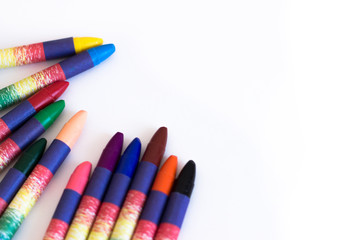 Fototapeta premium Colored wax pencils on a white background close-up